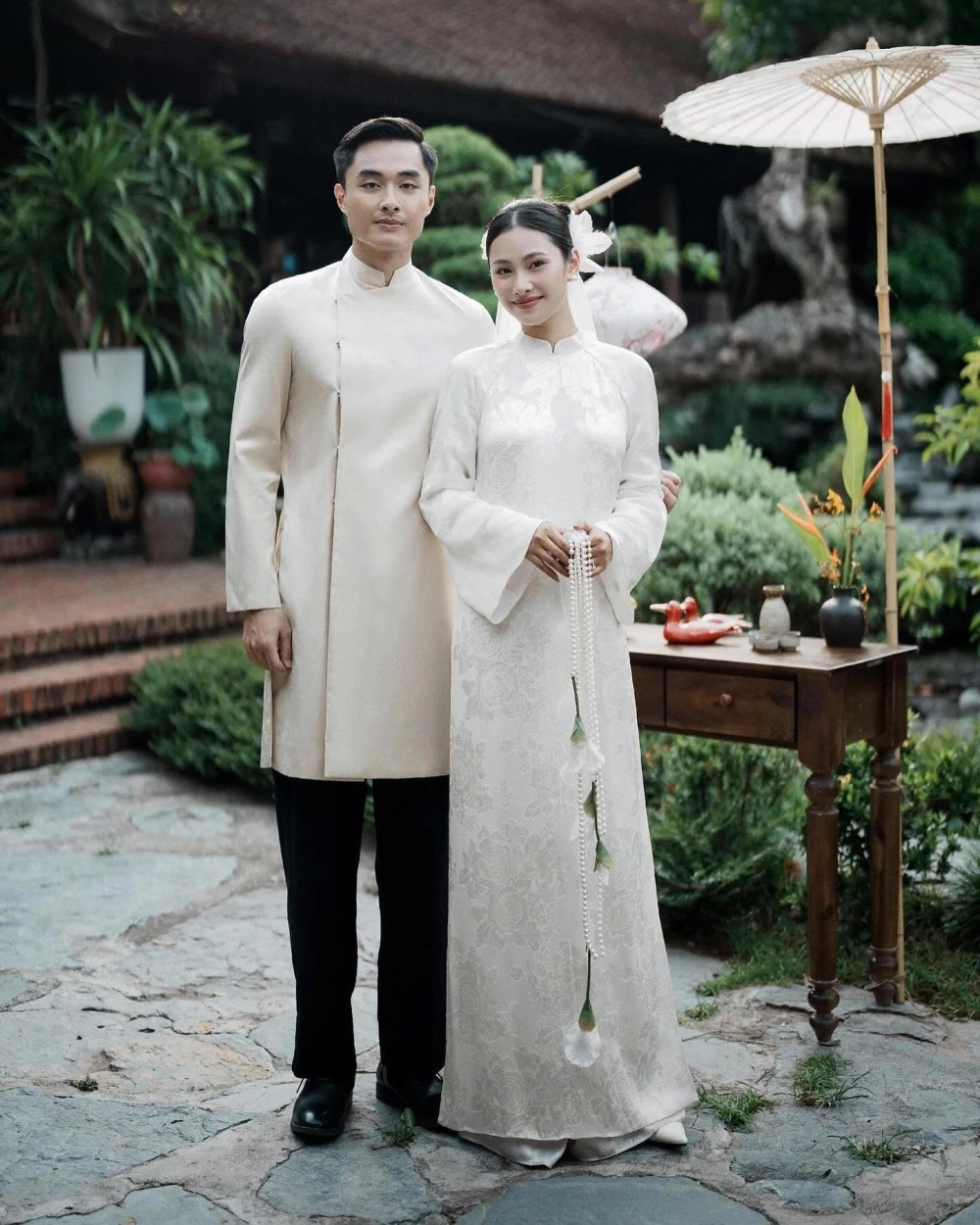 Áo dài gấm cặp màu xanh ngọc trẻ trung nhưng không kém phần quý tộc