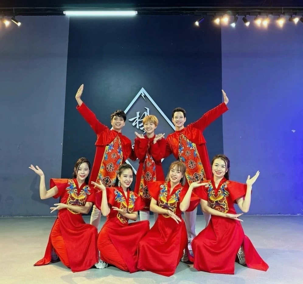 Áo dài múa gấm màu xanh cổ vịt, họa tiết rồng phượng sắc nét