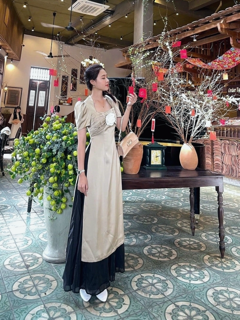 Áo dài tay phồng drap ngực màu vàng đồng chất liệu lụa, phối cùng chân váy midi