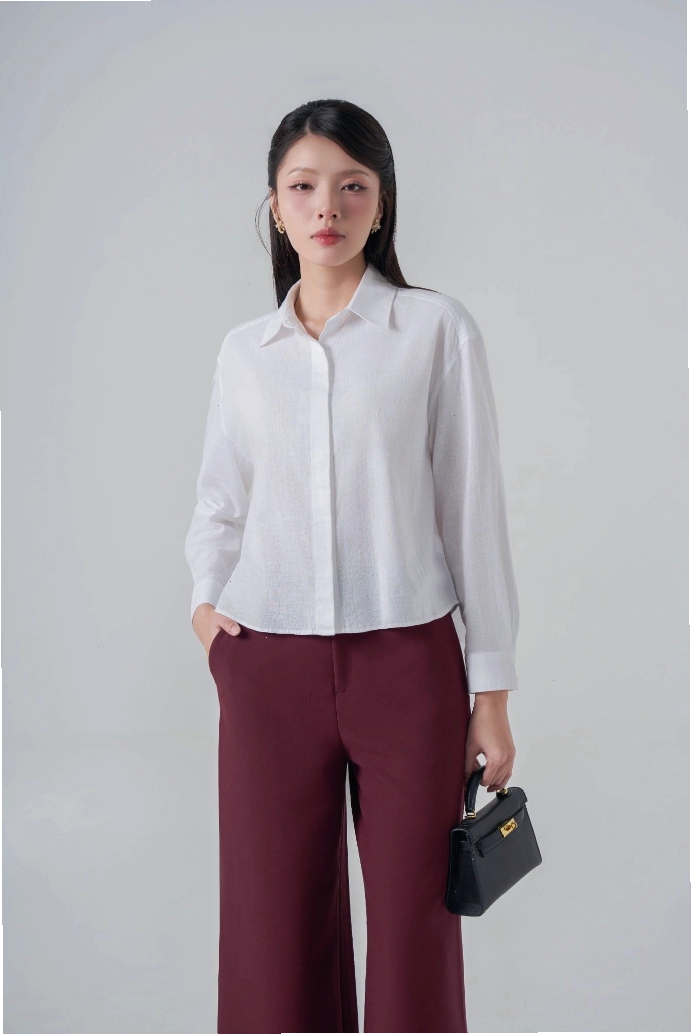 Áo sơ mi nữ dài tay màu hồng pastel, cổ bẻ, cài khuy, tay áo phồng nhẹ