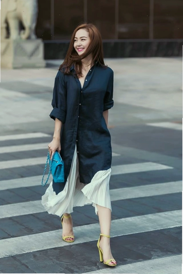 Áo sơ mi nữ form rộng dáng dài phối cùng đầm body và giày sneaker