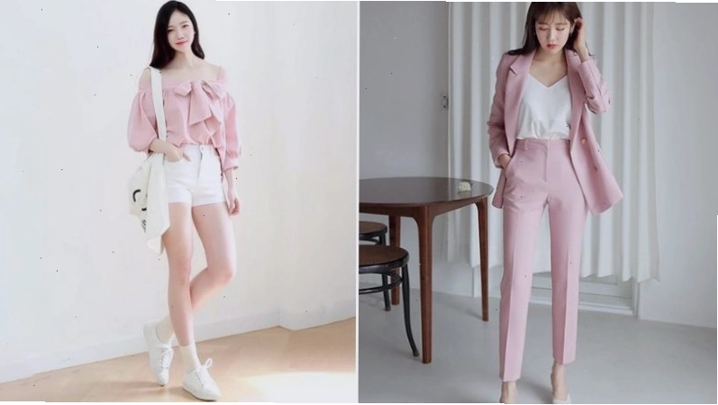 Cặp đôi mặc trang phục hồng pastel và trắng, tạo dáng vui vẻ trên đường phố