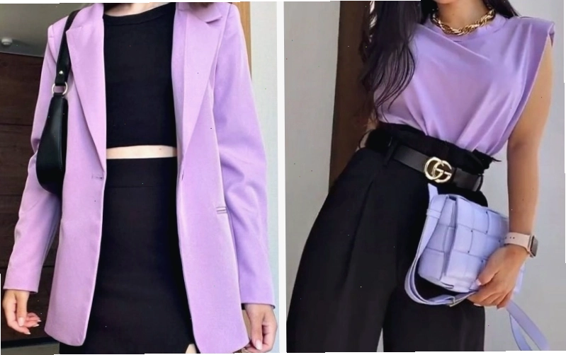 Cặp đôi mặc trang phục tím và đen, tạo dáng tình tứ trong một không gian tối giản.
