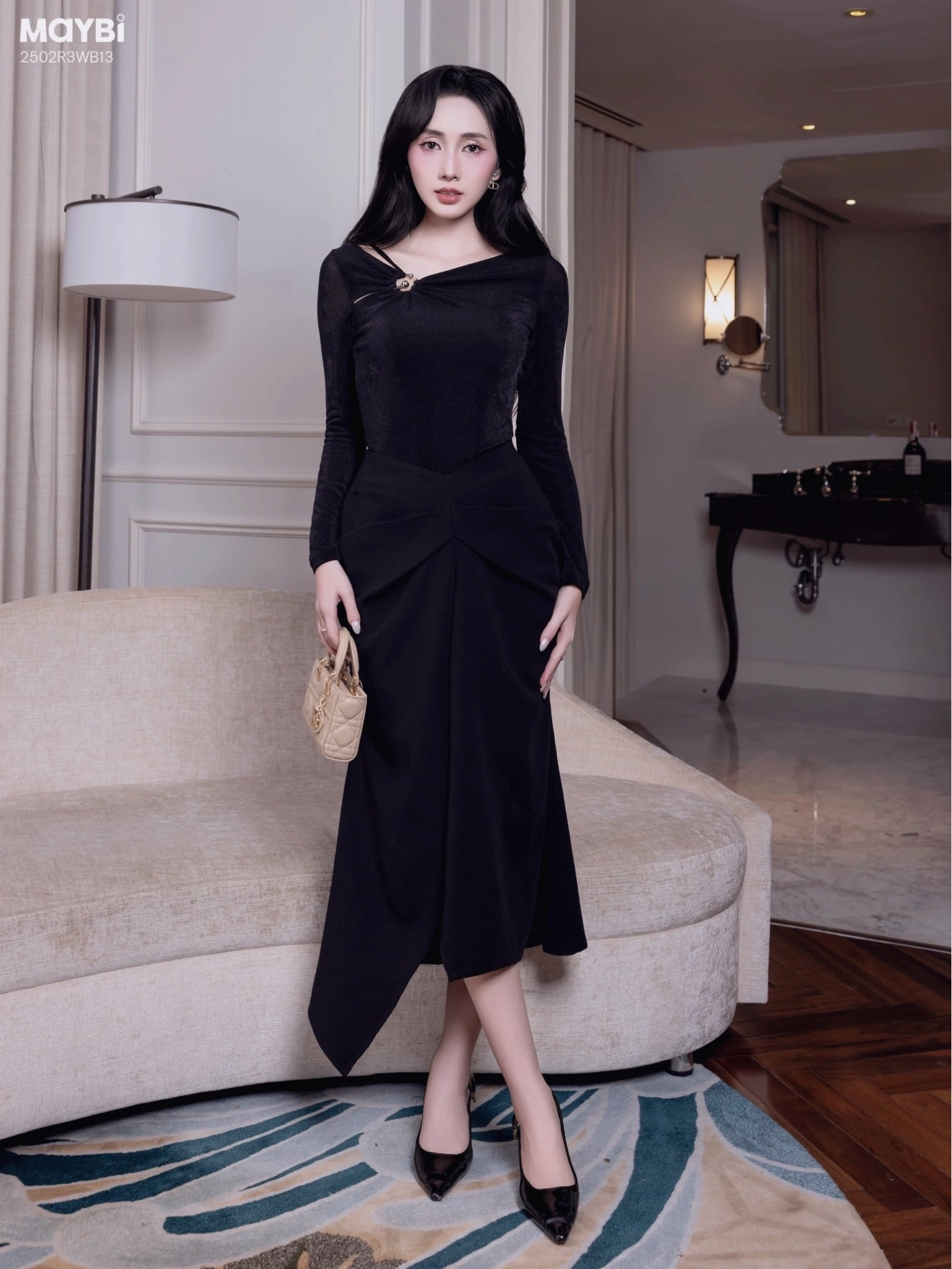 Chân váy midi ôm tuyết mưa phối xếp ly kiểu dáng chữ A màu be, dài qua gối, tạo hiệu ứng thon gọn cho đôi chân