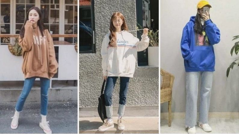 Cô gái diện áo hoodie màu xám, quần jean xanh và giày sneaker trắng