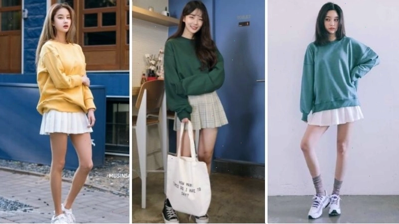 Cô gái diện áo sweater nâu phối cùng chân váy tennis đen và giày búp bê
