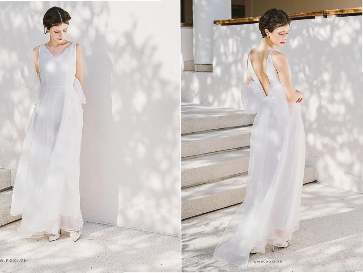 Cô gái mặc váy maxi dáng dài màu xanh dương trơn, cổ yếm, xẻ tà