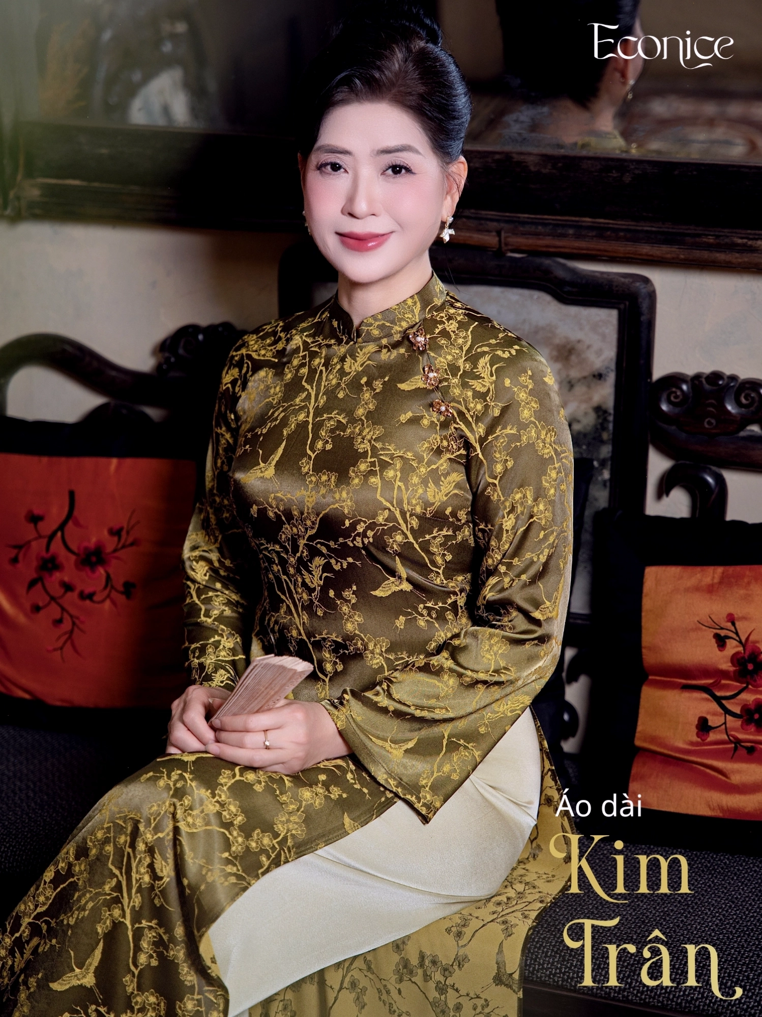 Set áo dài cách tân màu xanh rêu, cổ thuyền, tay lỡ, phối cùng quần lụa trắng.